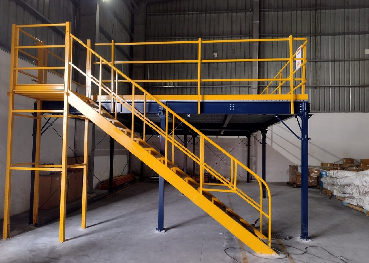 Steel mezzanine floor system with staircase in a warehouse
